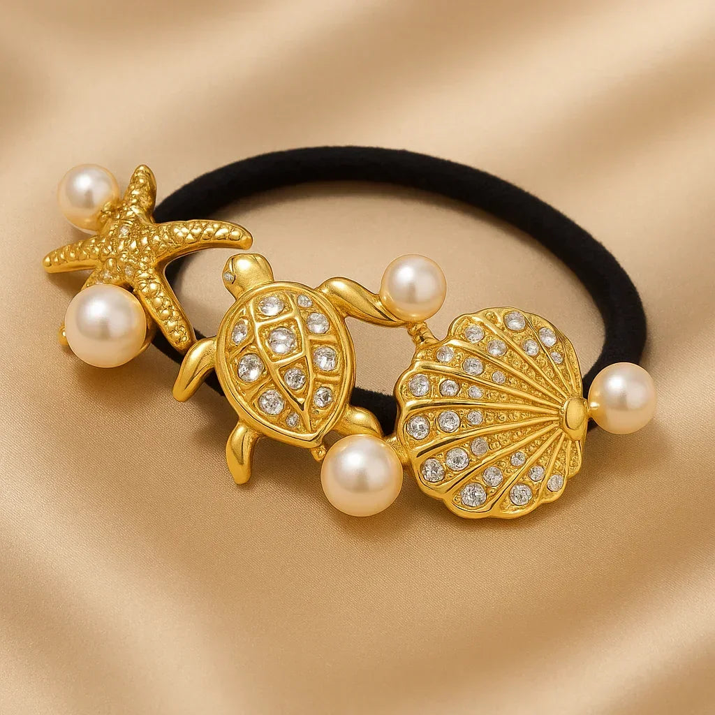 Ălastique Ă cheveux noir avec dĂ©corations marines dorĂ©es : Ă©toile de mer, tortue, coquillage et perles