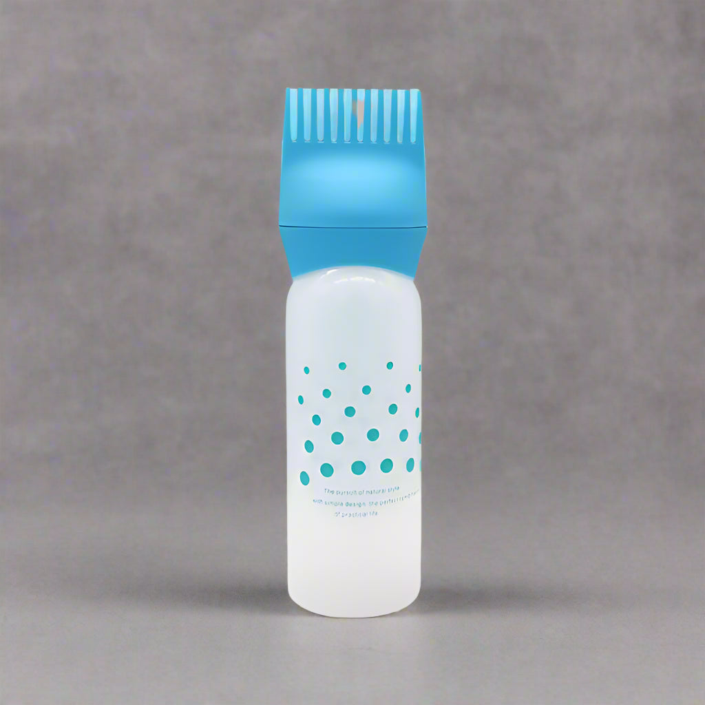 Applicateur d'huile bleu, conçu pour une application précise et homogÚne des huiles capillaires ou corporelles.