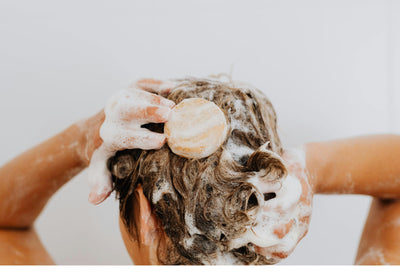 femme shampoing dans ses cheveux
