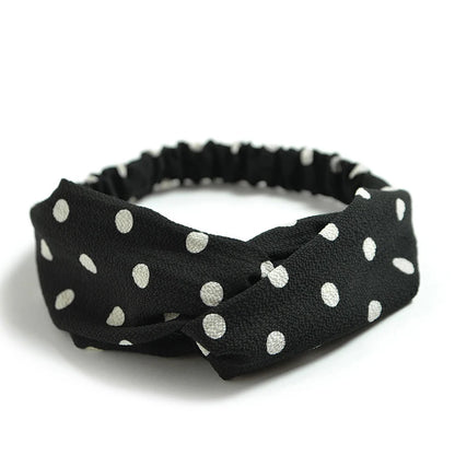 Élégant bandeau noir à pois blanc pour femme, un accessoire de mode incontournable pour compléter votre look.