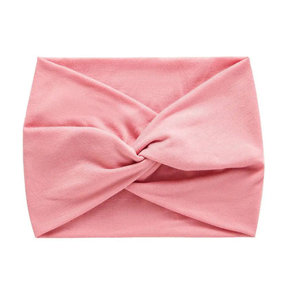 Bandeau pour cheveux rose au style sportwear, idéal pour maintenir les cheveux en place pendant le sport avec une touche féminine
