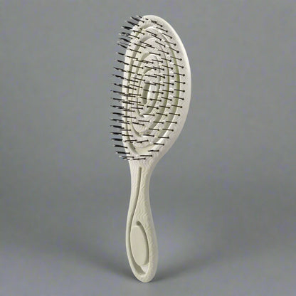 Brosse beige  à cheveux pour boucles, antistatique et démêlante, idéale pour cheveux bouclés ou frisés, avec picots souples pour un coiffage sans frisottis.