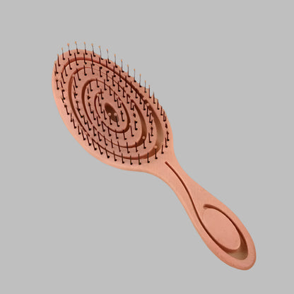 Brosse orange à cheveux pour boucles, antistatique et démêlante, idéale pour cheveux bouclés ou frisés, avec picots souples pour un coiffage sans frisottis.