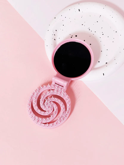 Brosse à cheveux de voyage rose, compacte et pratique, idéale pour un coiffage rapide en déplacement