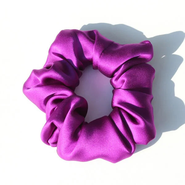Chouchou en soie violet, élégant et doux au toucher, avec finition satinée, idéal pour préserver les cheveux tout en ajoutant une touche chic et raffinée à votre coiffure