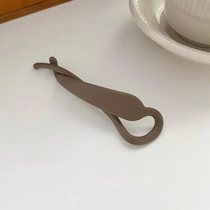 Pince à cheveux plastique , de taille moyenne, conçue pour maintenir les cheveux en place de manière pratique et sécurisée, avec un design simple et fonctionnel