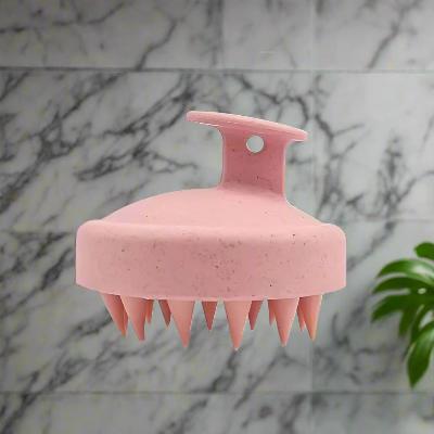 Brosse pour cheveux rose démêlante avec picots massants, conçue pour démêler en douceur tout en stimulant le cuir chevelu